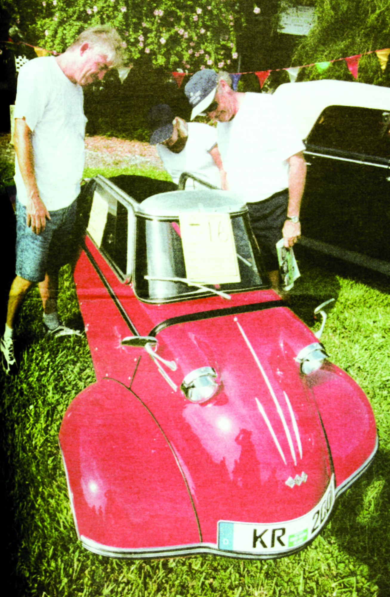 Two men check out one of the cars on display on St. Armands Circle.