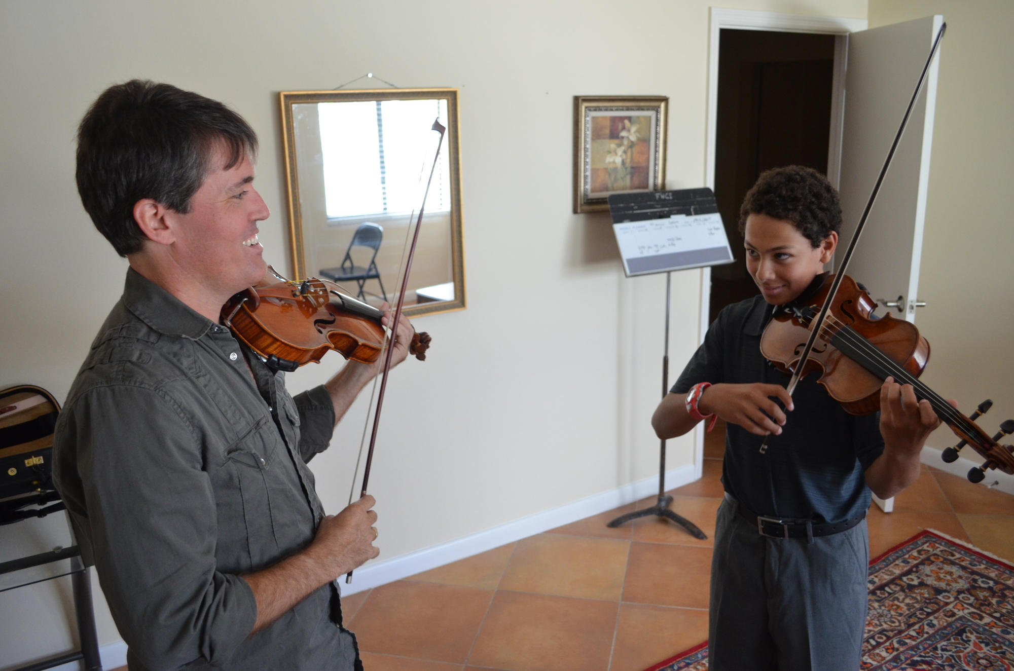 Sean O’Neil and Sarasota Music Conservatory student Giordano Scarano play during a lesson in the conservatory’s new space.