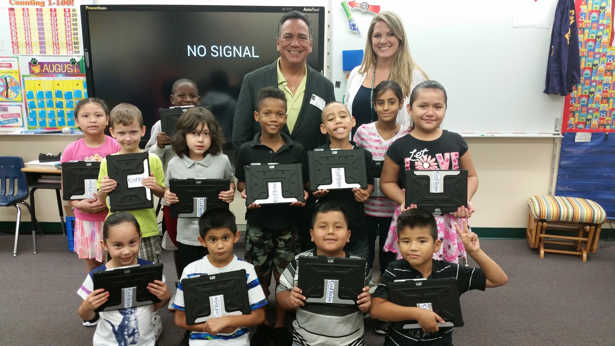 Courtesy photo. Jaime DiDomenico of Cool Today & Plumbing Today donates 18 tablet cases to Ashley Najjar's second grade class at Wilkinson Elementary School.