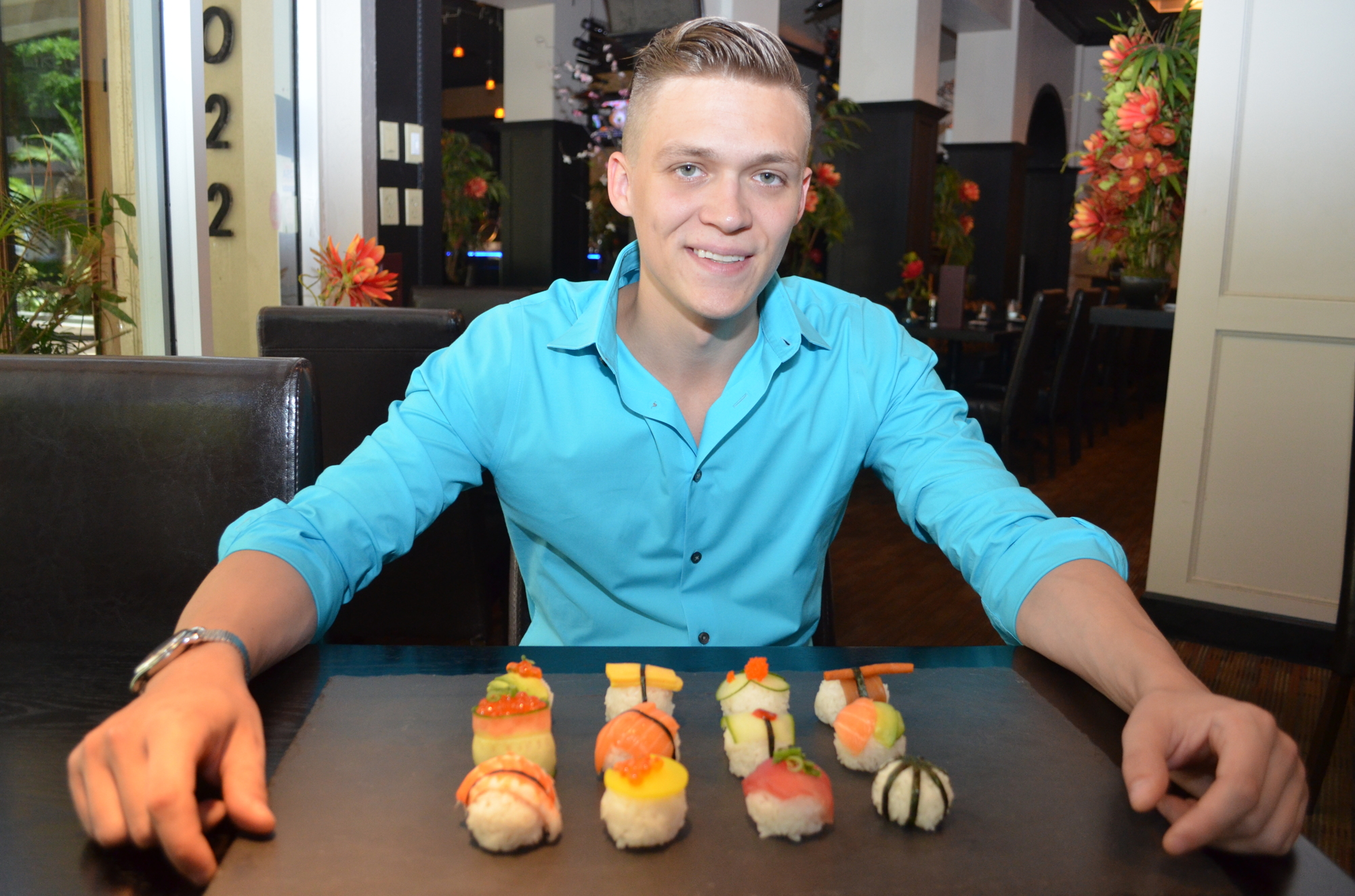 Sam Ray, co-owner of Tsunami Sushi, with the colorful sushi created for the Art of Food Festival inspired by the Sarasota Opera
