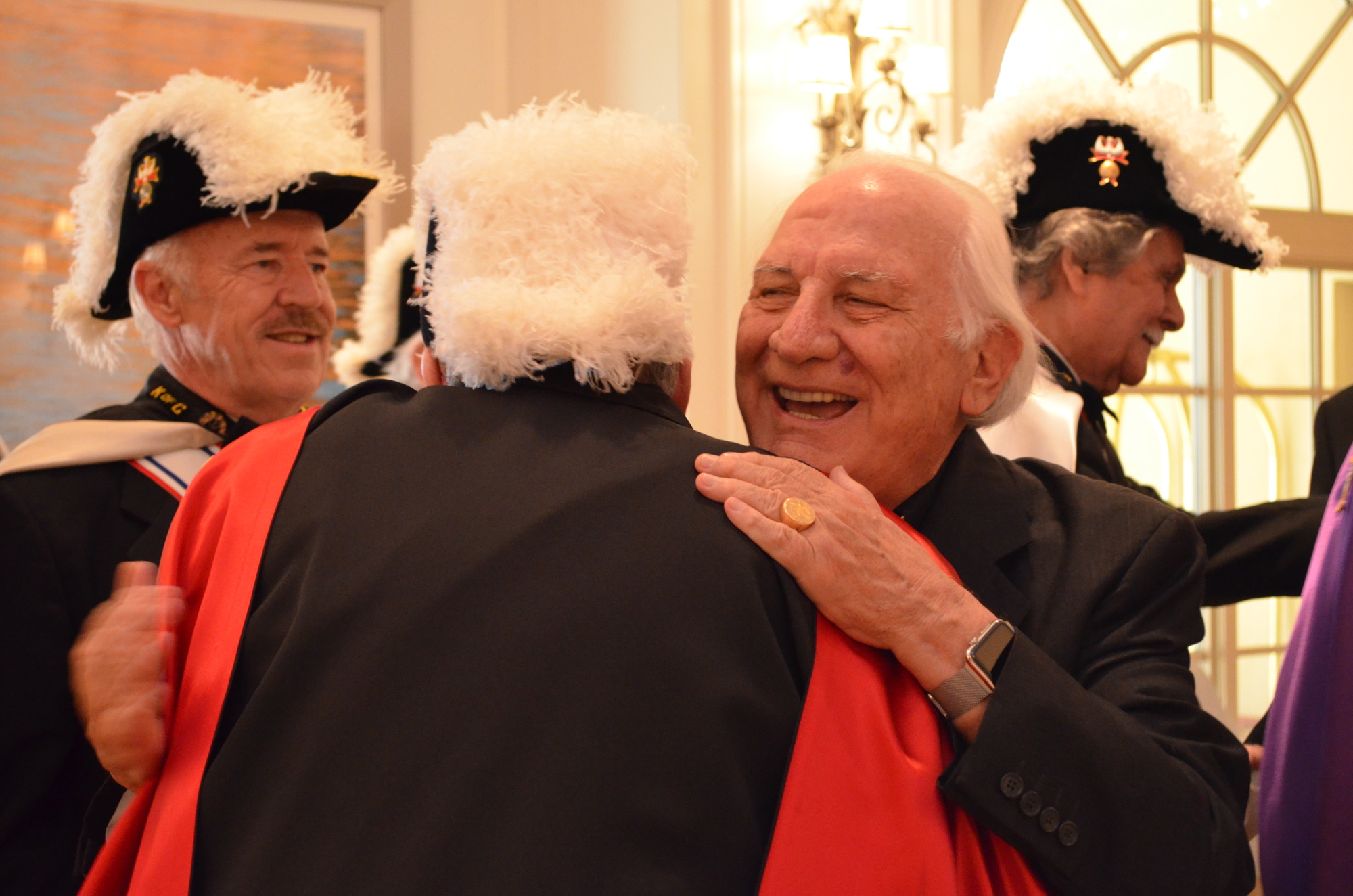 Father Fausto hugs and thanks Robert Morrissey of the Knights of Columbus for the entrance.