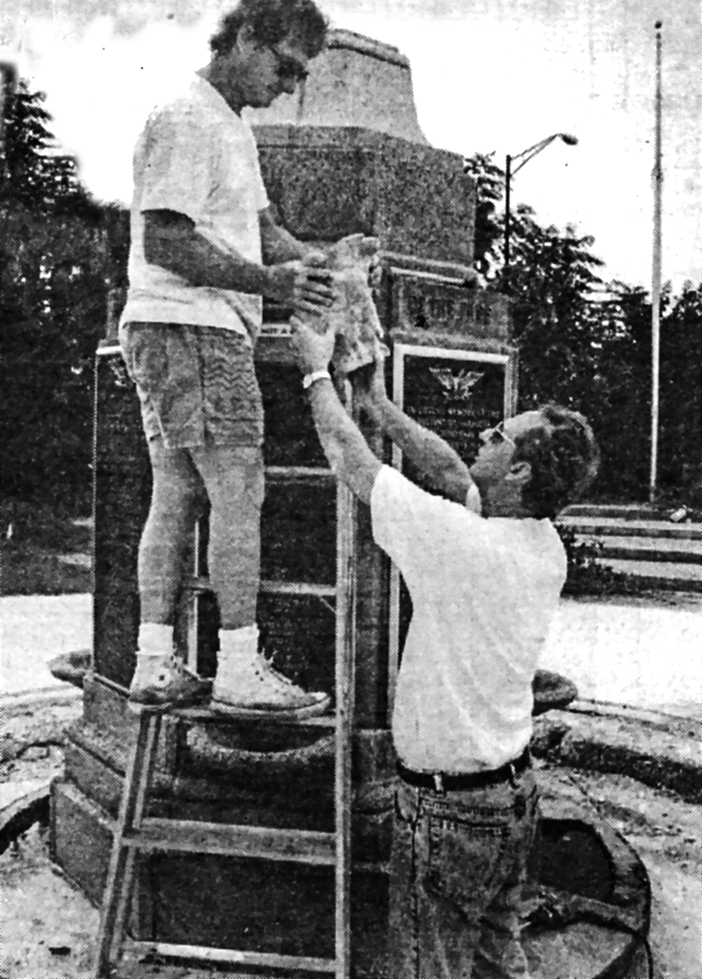 Brian Bishop, then president of the Sarasota County Homebuilders Association, and former Sarasota Mayor Jack Gurney install recast eagles on the Veterans' Monument in JD Hamel Park.