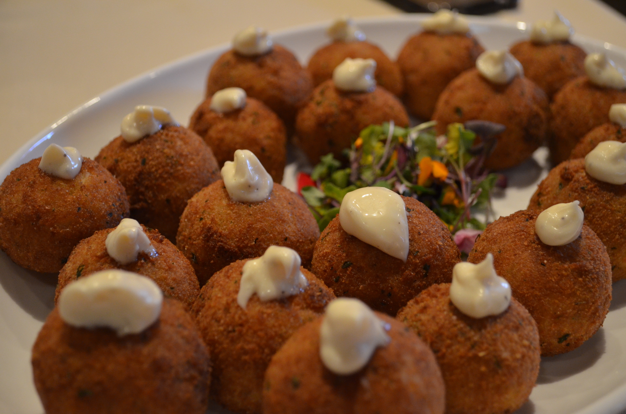 A plate of arancini infused with truffle butter.