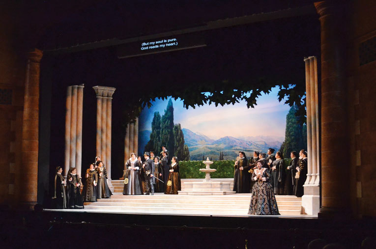 The stage in Act II includes a bright and palatial garden where Mary Phillips, as Princess Eboli, holds court.