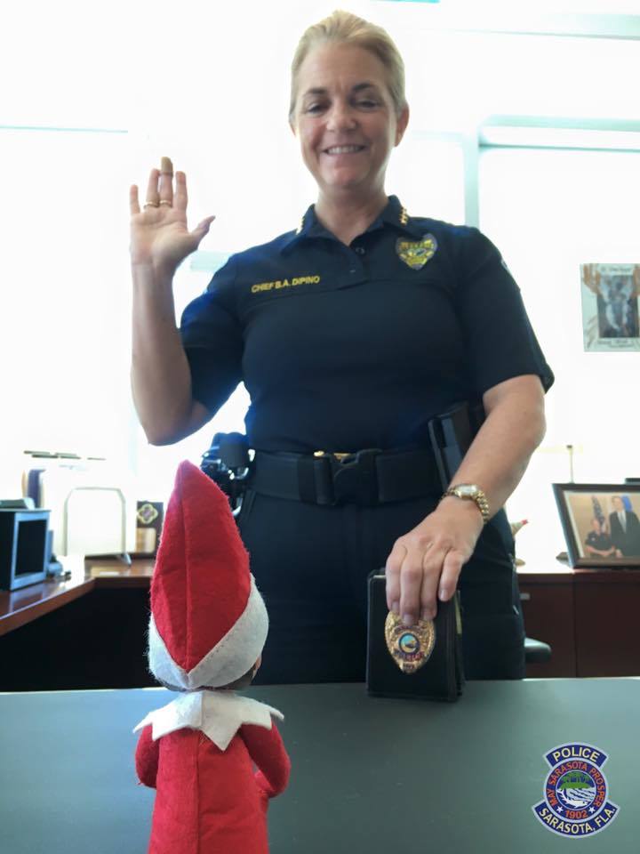 Courtesy photo. Officer Elf On A Shelf is sworn in by Sarasota Police Chief Bernadette DiPino.