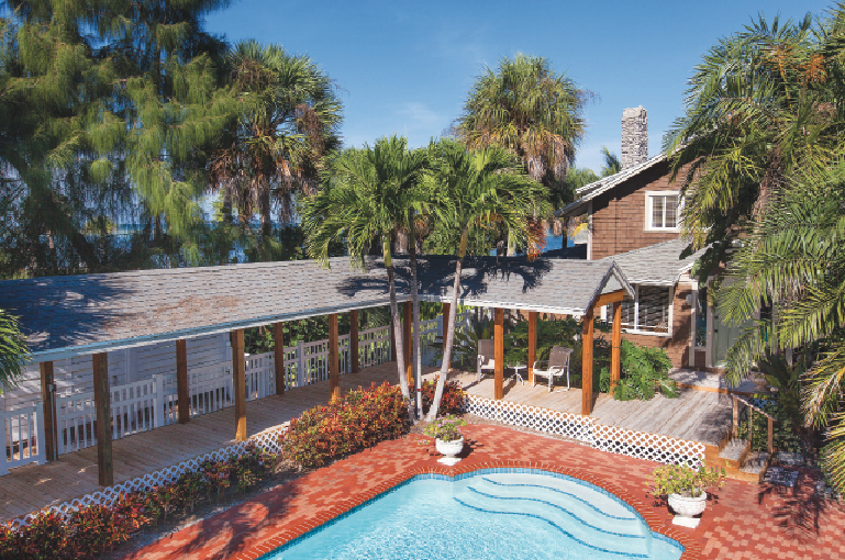 A pool and deck are tucked between the guest house and the main house.