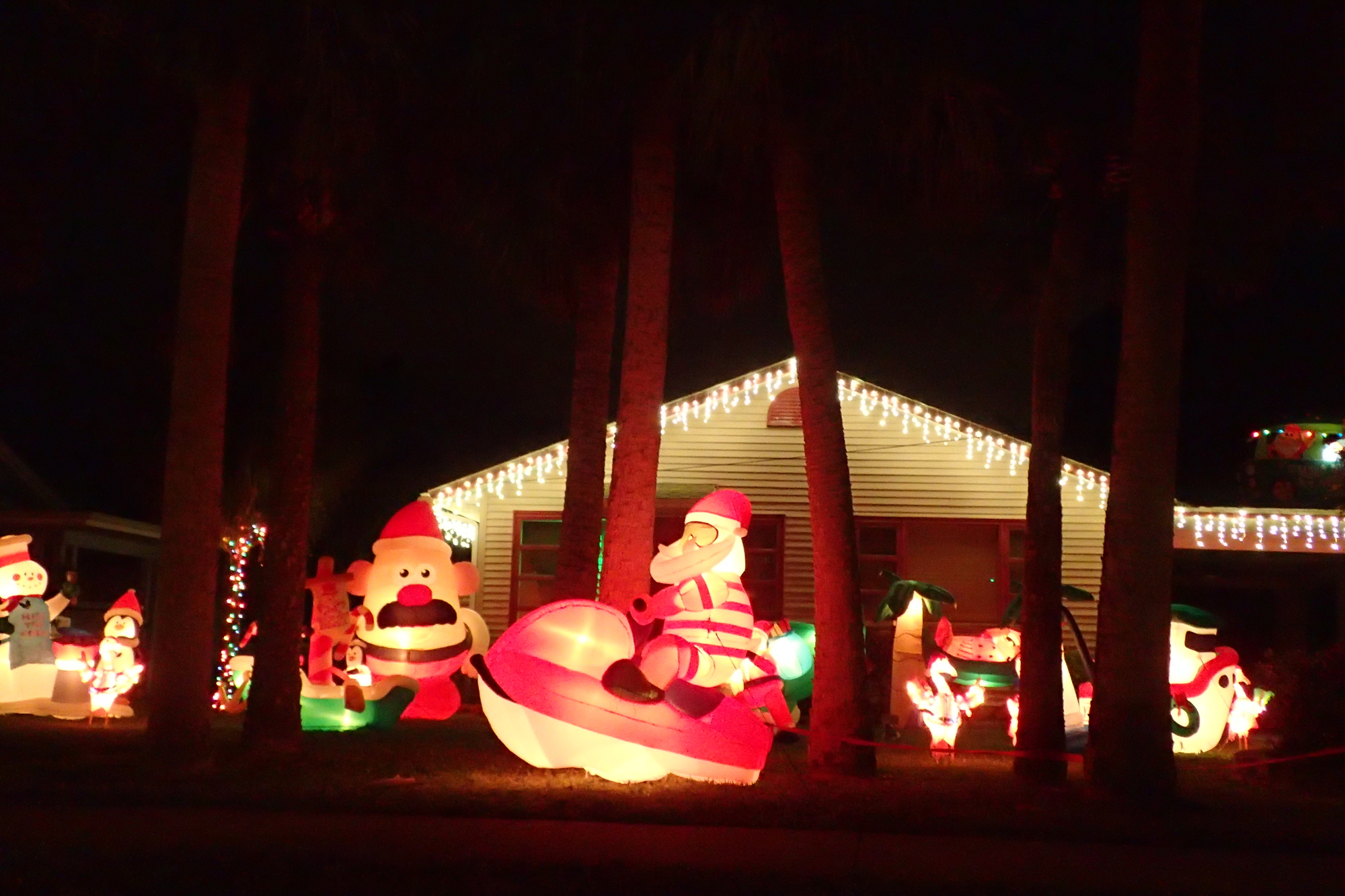 Santa rides a personal watercraft on the lawn of this home at 99 Avenida Messina.