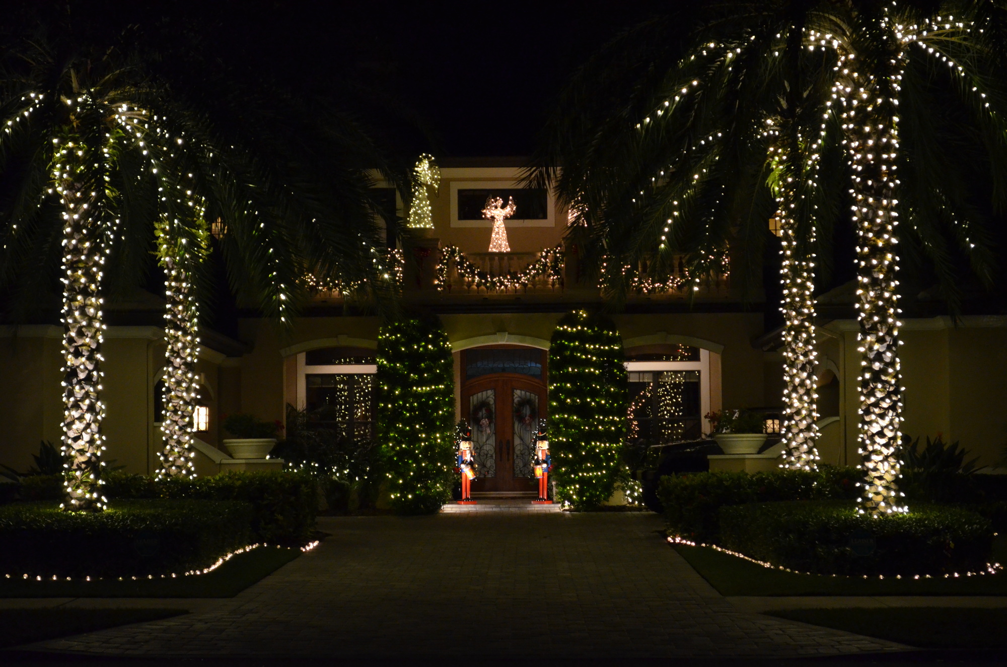 This home at 1758 Cherokee Drive gives a regal welcome with palm trees lit up.
