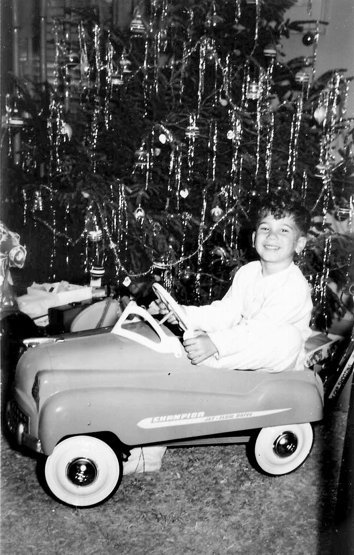 A young Larry Kelleher in front of the family Christmas tree with tinsel that he used to love to roll into a ball and throw at friends.