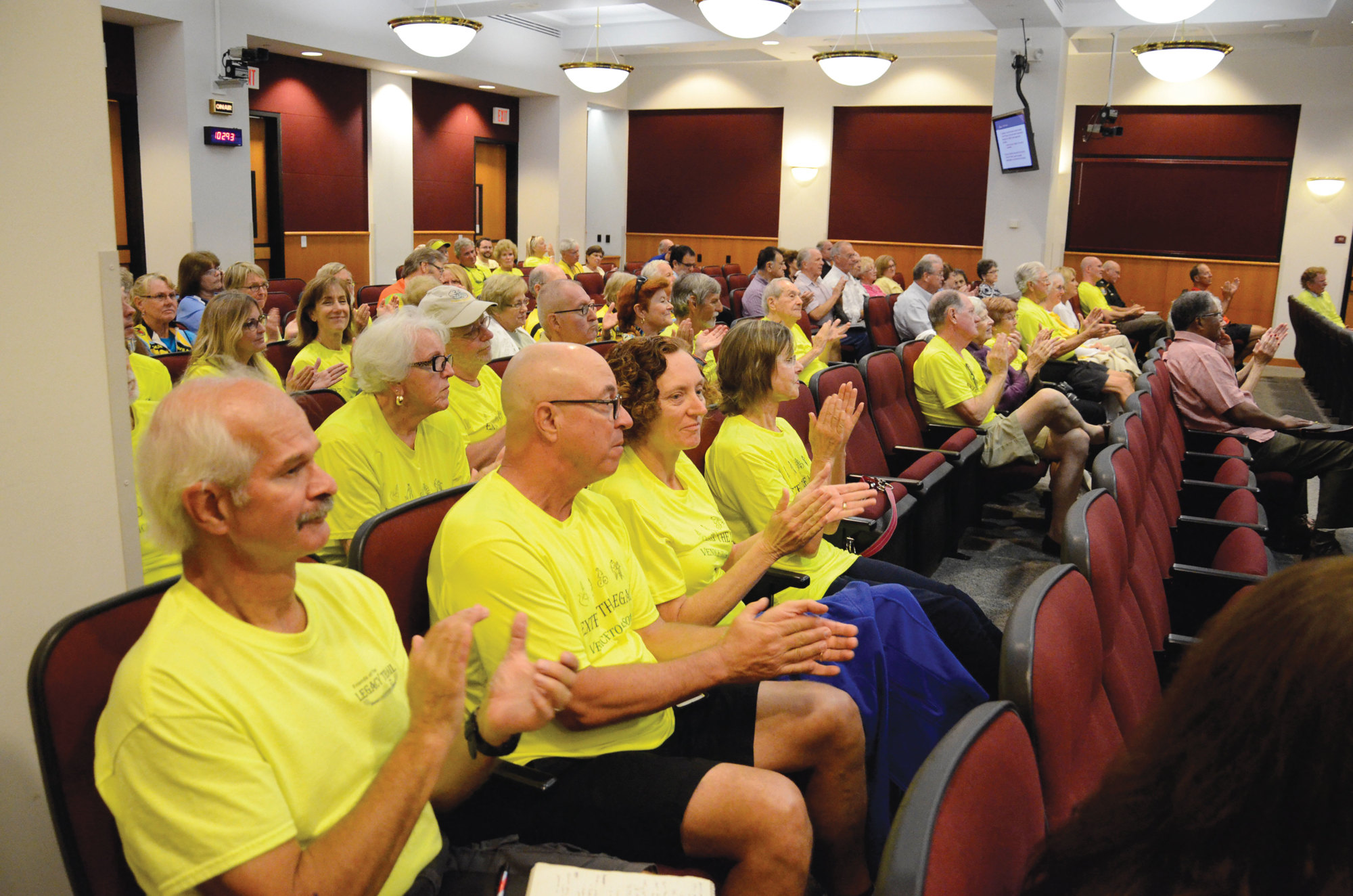 Residents who support the Legacy Trail extension applaud as county commissioners approve the feasibility study.
