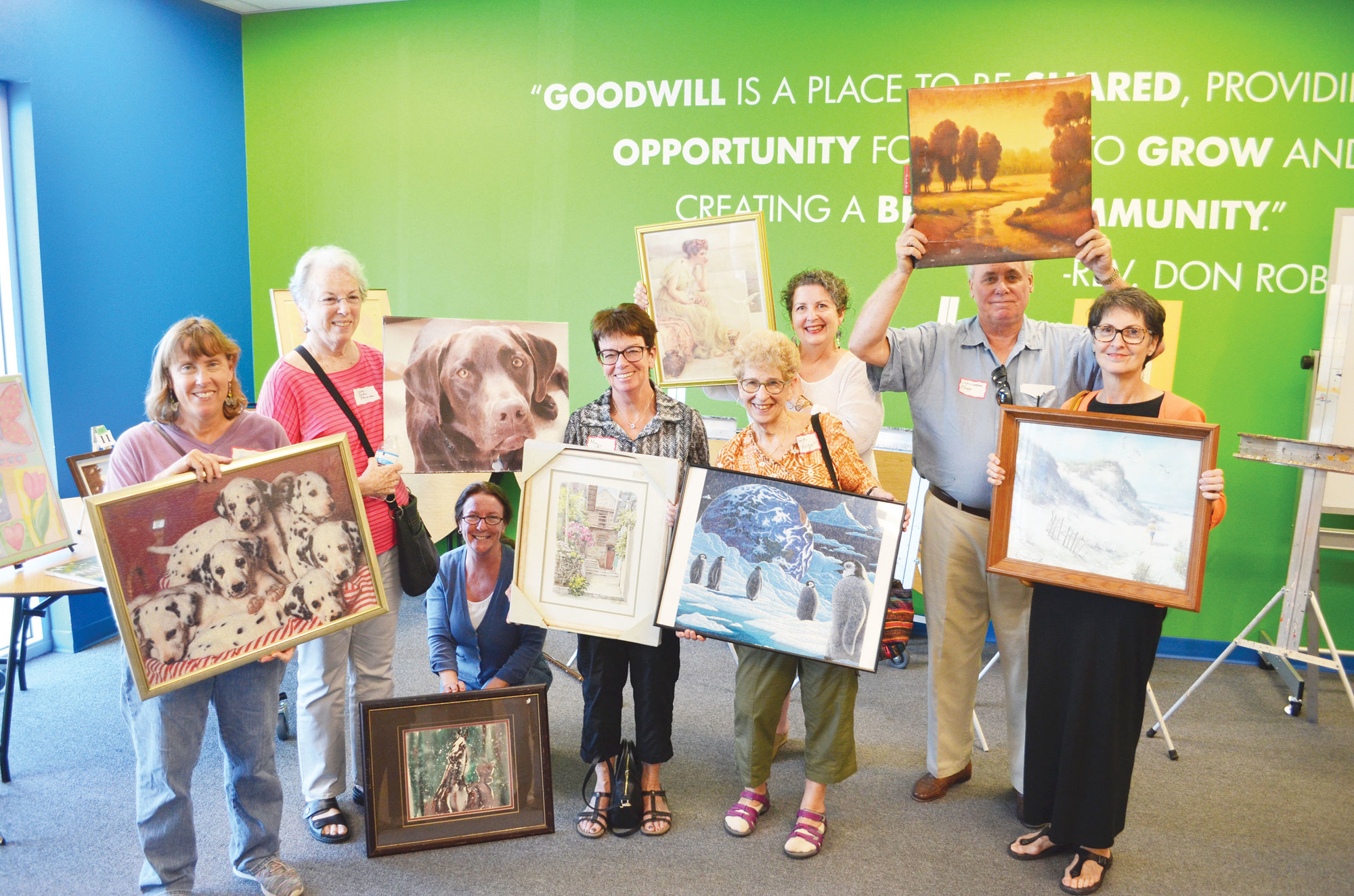 “MASHterpiece” artists hold up their artistic spoils from Goodwill.
