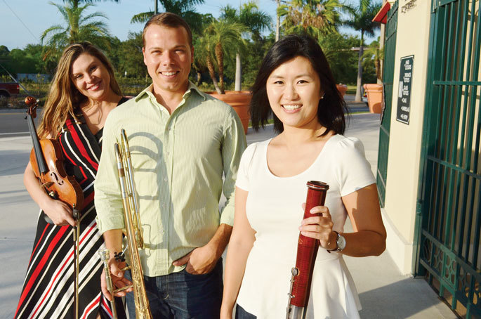 As soon as the Sarasota Orchestra musicians arrived at Ed Smith Stadium last week, they started tuning and playing their respective instruments with trombonist Brad Williams, middle.
