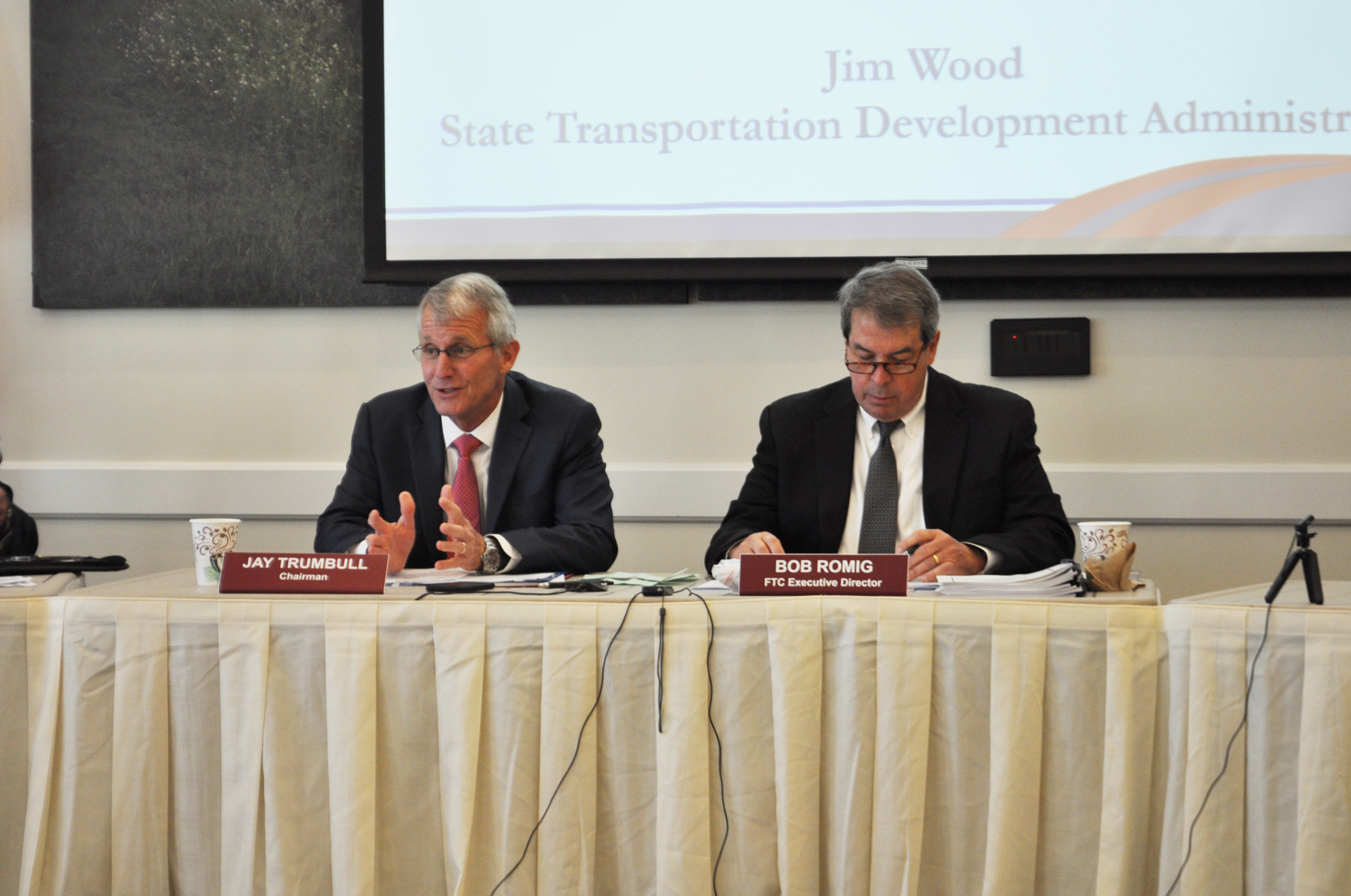 Chairman Jay Trumbull welcomes guests, as he sits by FTC Executive Director Bob Romig.
