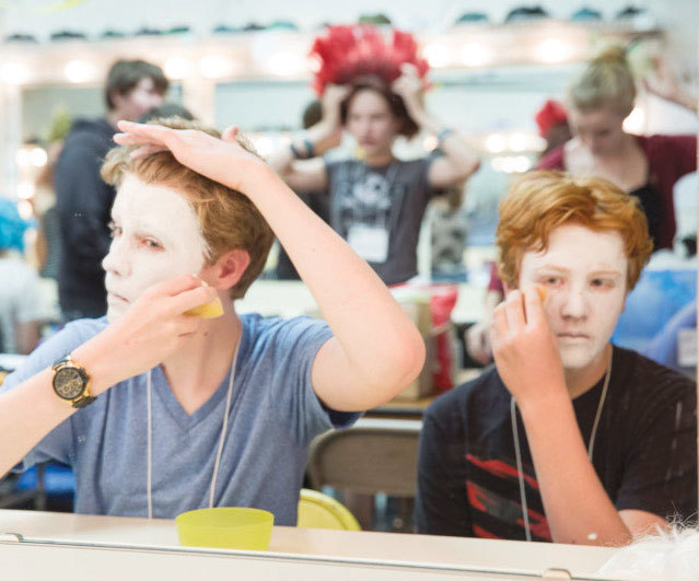 Graham Beckstein and Josh Van Dyke learn the art and craft of stage makeup. Photo by Rod Millington.