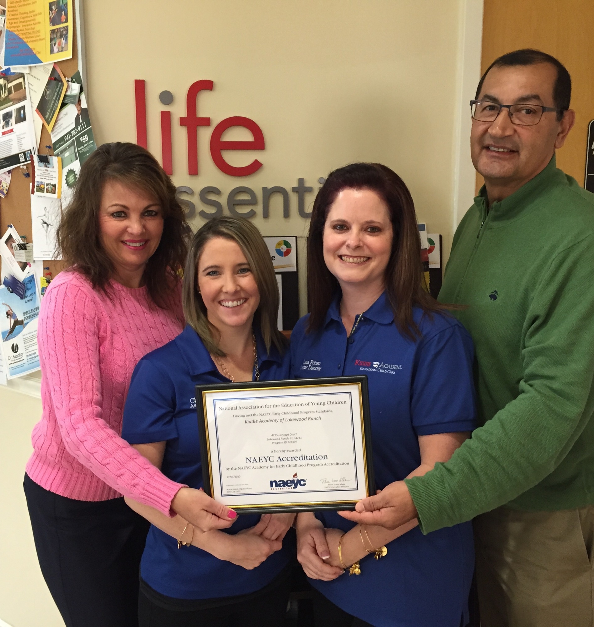 Marina Woolf-Schmidt, Chelsea Jervis, Tina Pouso and Bill Schmidt show off Kiddie Academy's National Accreditation certificate.