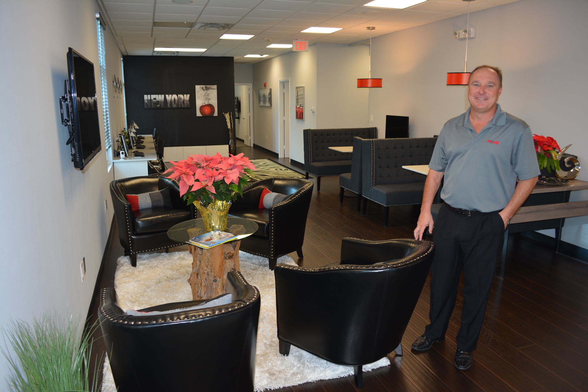 Shaun Peens, the broker and owner of RE/MAX Fine Properties in Lakewood Ranch, shows off the cafe-style office that is designed to attract younger clients.
