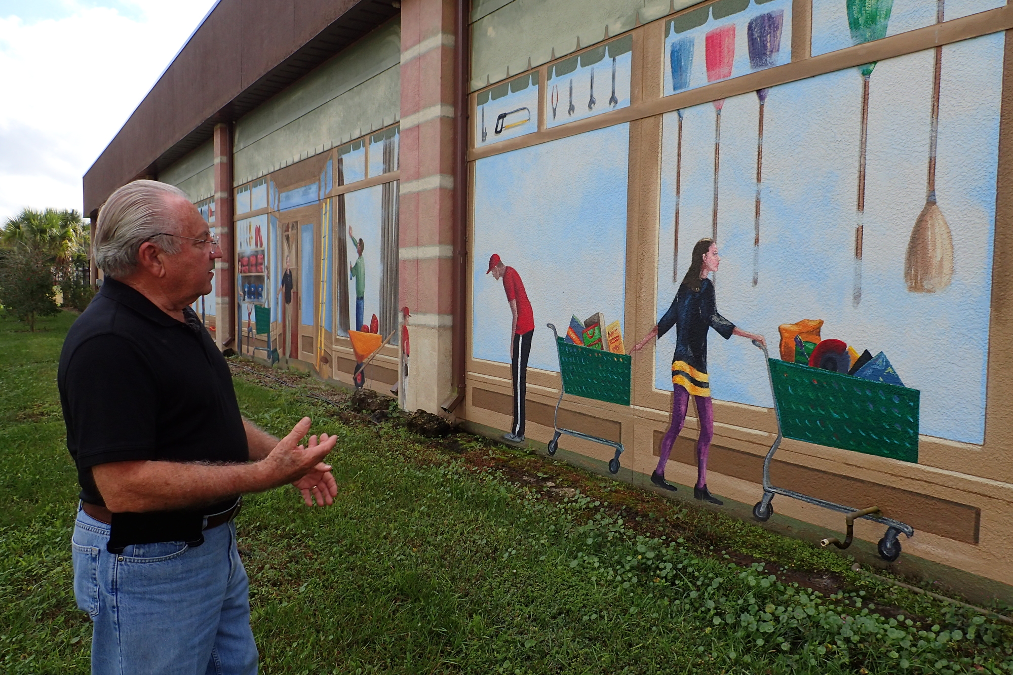 Al Bavry, owner of Kimal Hardware on Fruitville Road, looks over the murals that the county says violate codes by advertising the business.