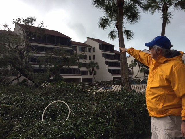 Dr. Marc Blum points to the building five condominium at Excelsior Gulf to Bay condominium that lost its roof in the storm. Standing in the courtyard, one could see through the units to the side where many of the windows are missing.