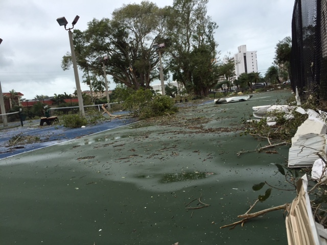 The tennis court at Excelsior's bayside units is littered with debris after the storm.