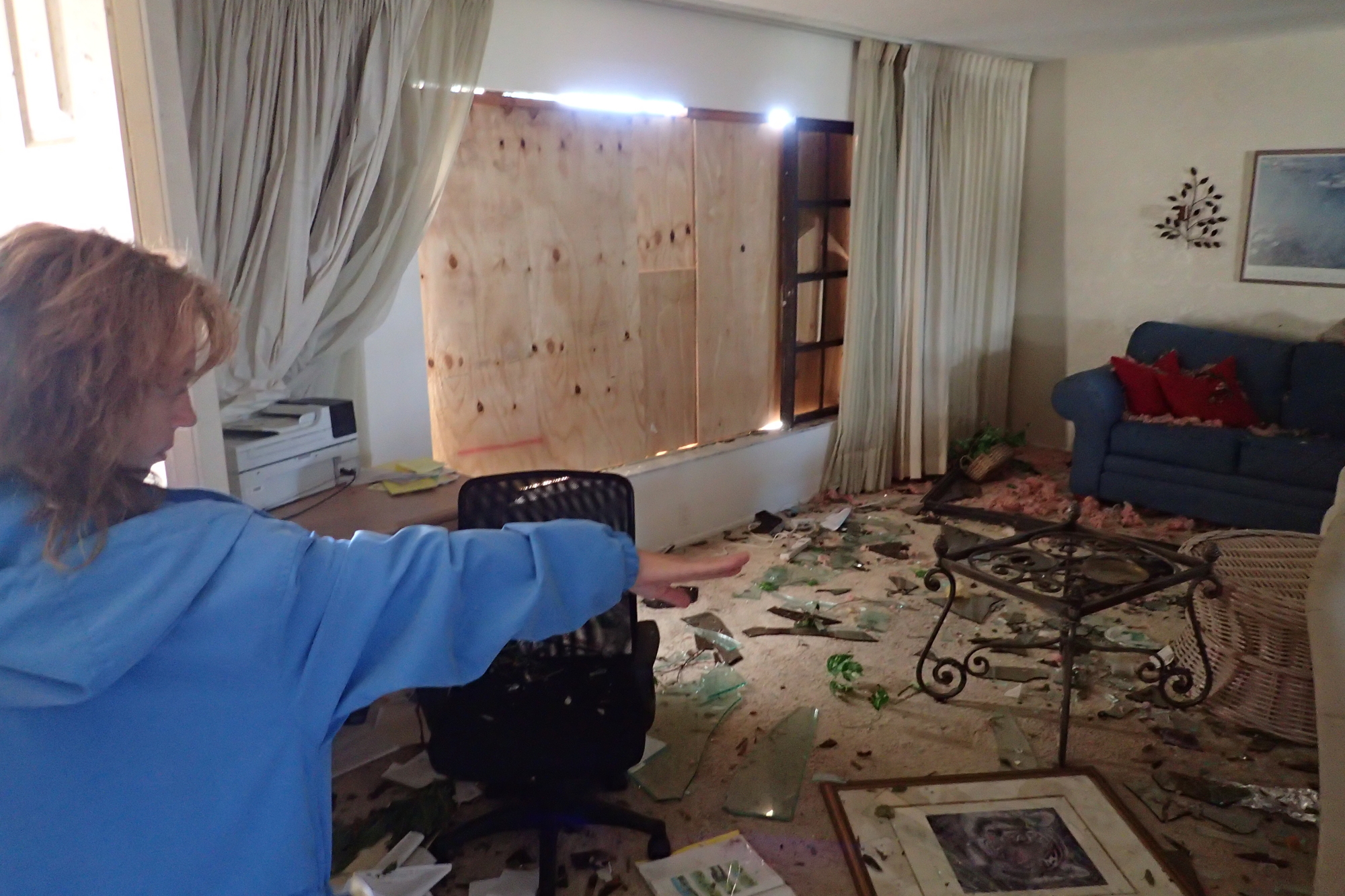 Pauline Vileno shows where winds tore through her home.