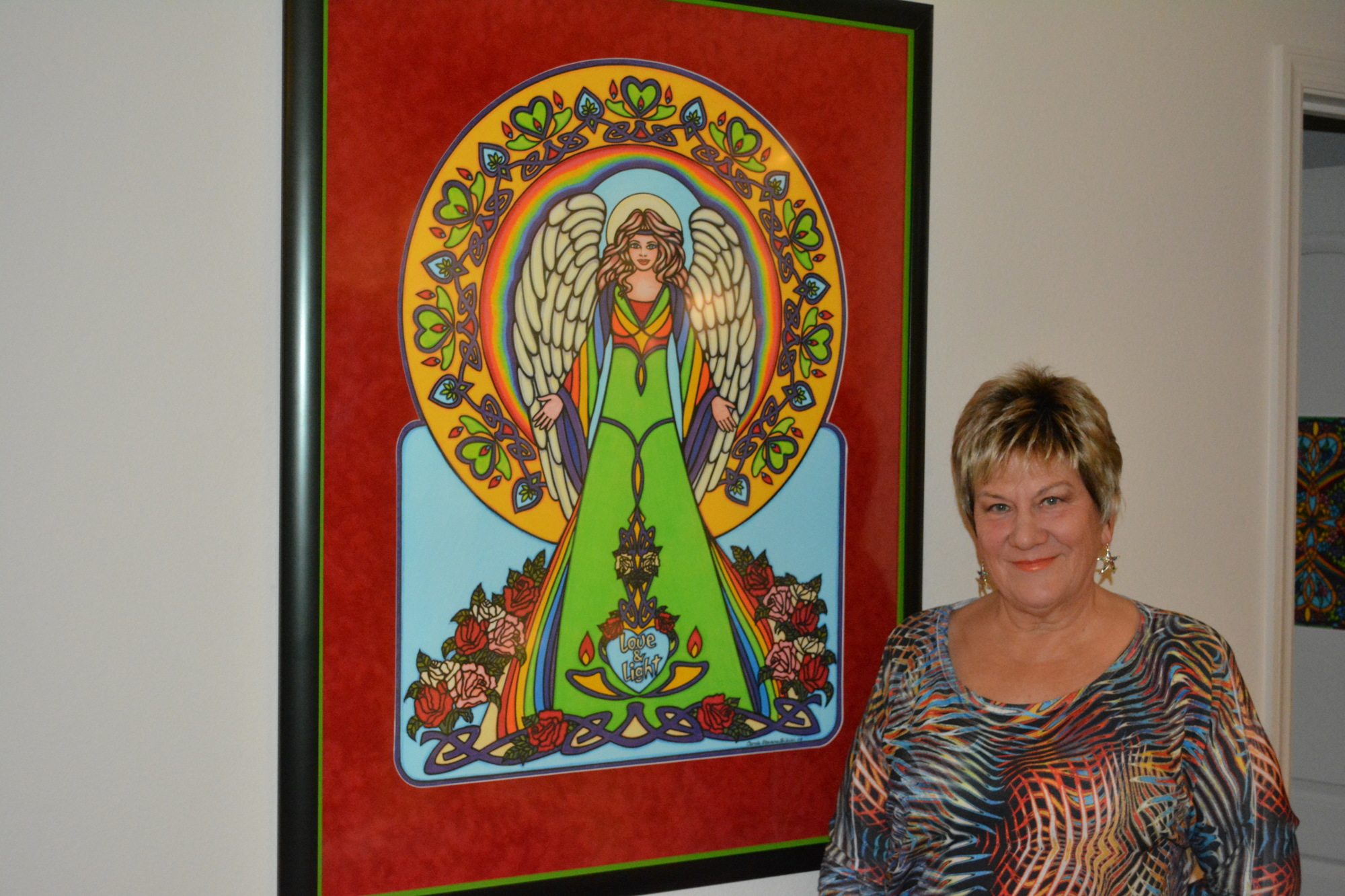 Carole Stevens Bibisi shows one of the many terrific pieces of art she draws with colored pencils.
