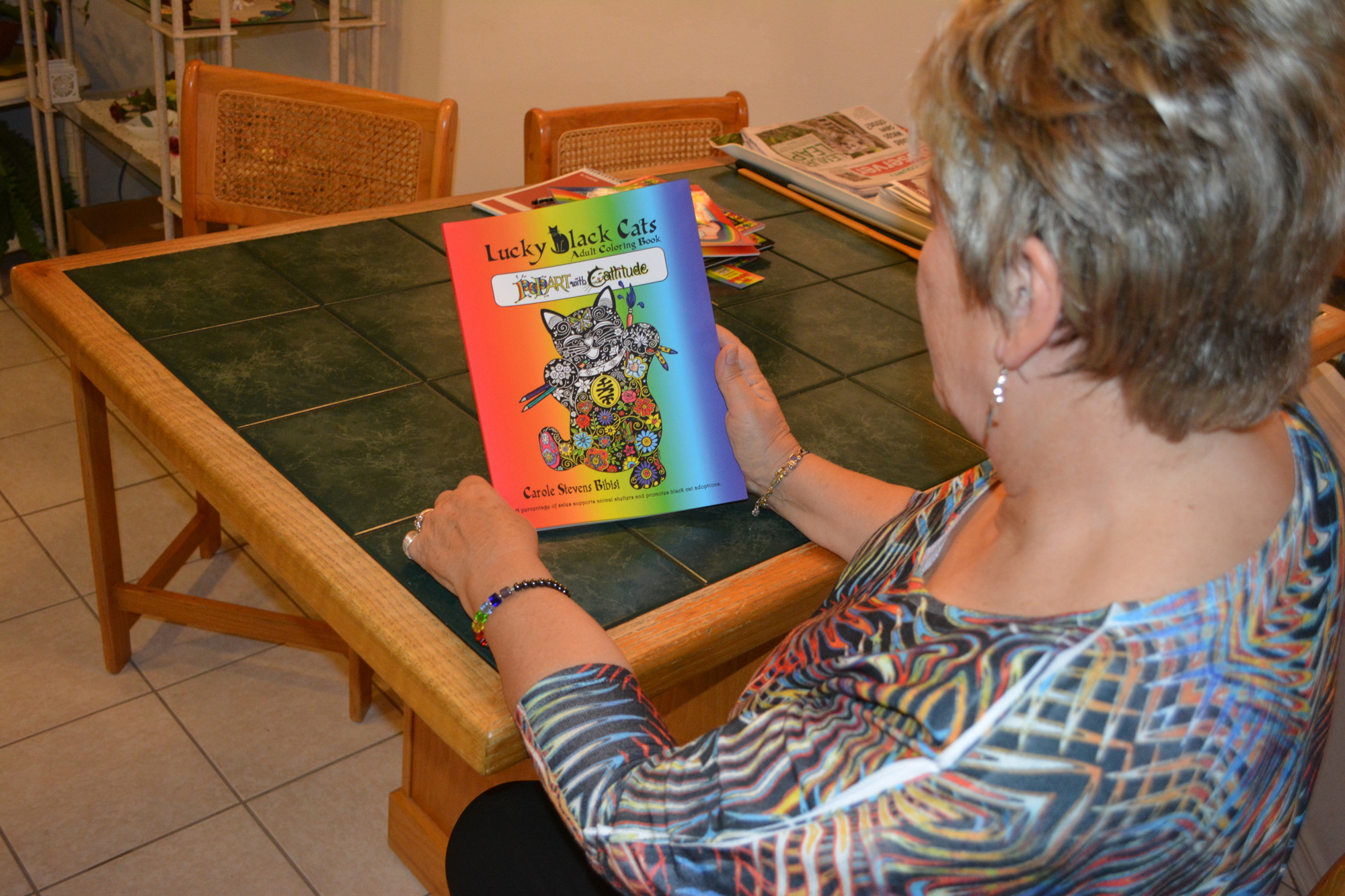 Carole Stevens Bibisi shows her first adult coloring book, Lucky Black Cats.