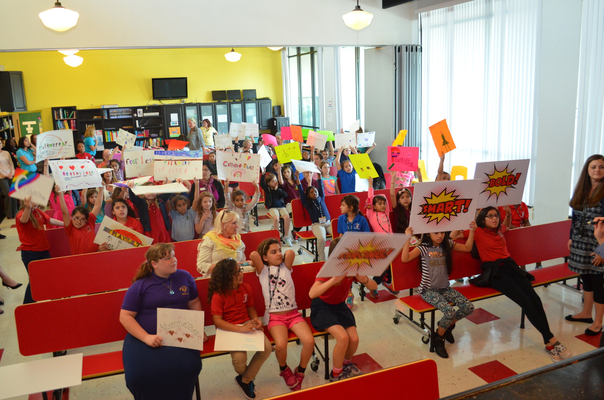 Girls Inc. members hold up signs inspired by qualities of the Girl of the Year recipient Tyesha Brown.