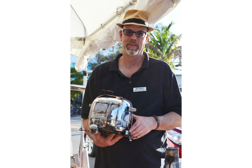 Dick Cooley is the artist behind Metal Sculpture which recycles metal pieces like spark plugs, spoons and gears at the 2015 Siesta Key Craft Festival.