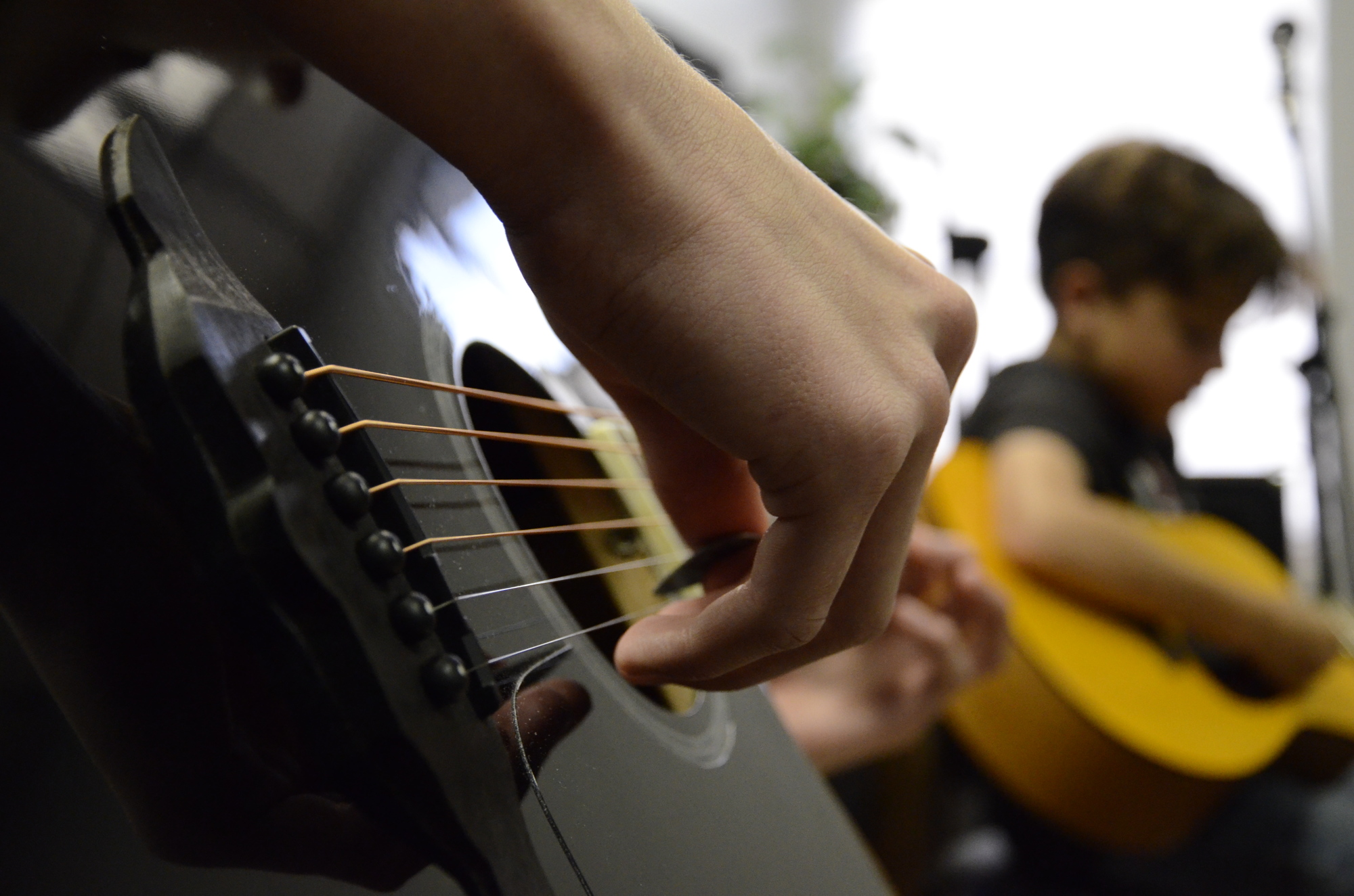 Ethan Charles, a Riverview High School student, practices guitar in a group class at Music Compound.