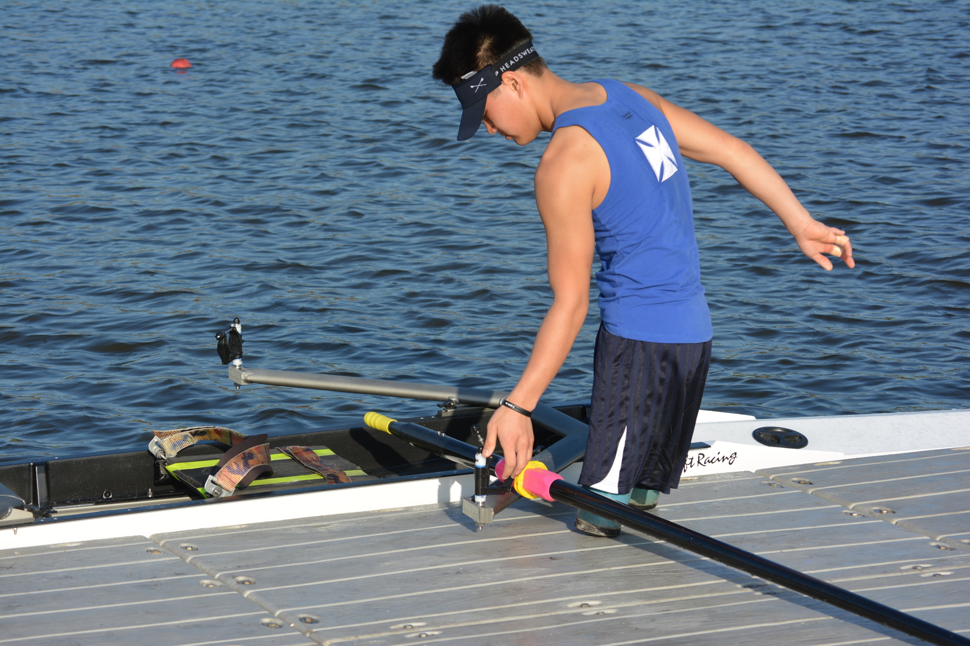 Isaac French takes the oars off his boat after finishing his run March 4 at the USRowing Para Rowing Camp at Nathan Benderson Park.