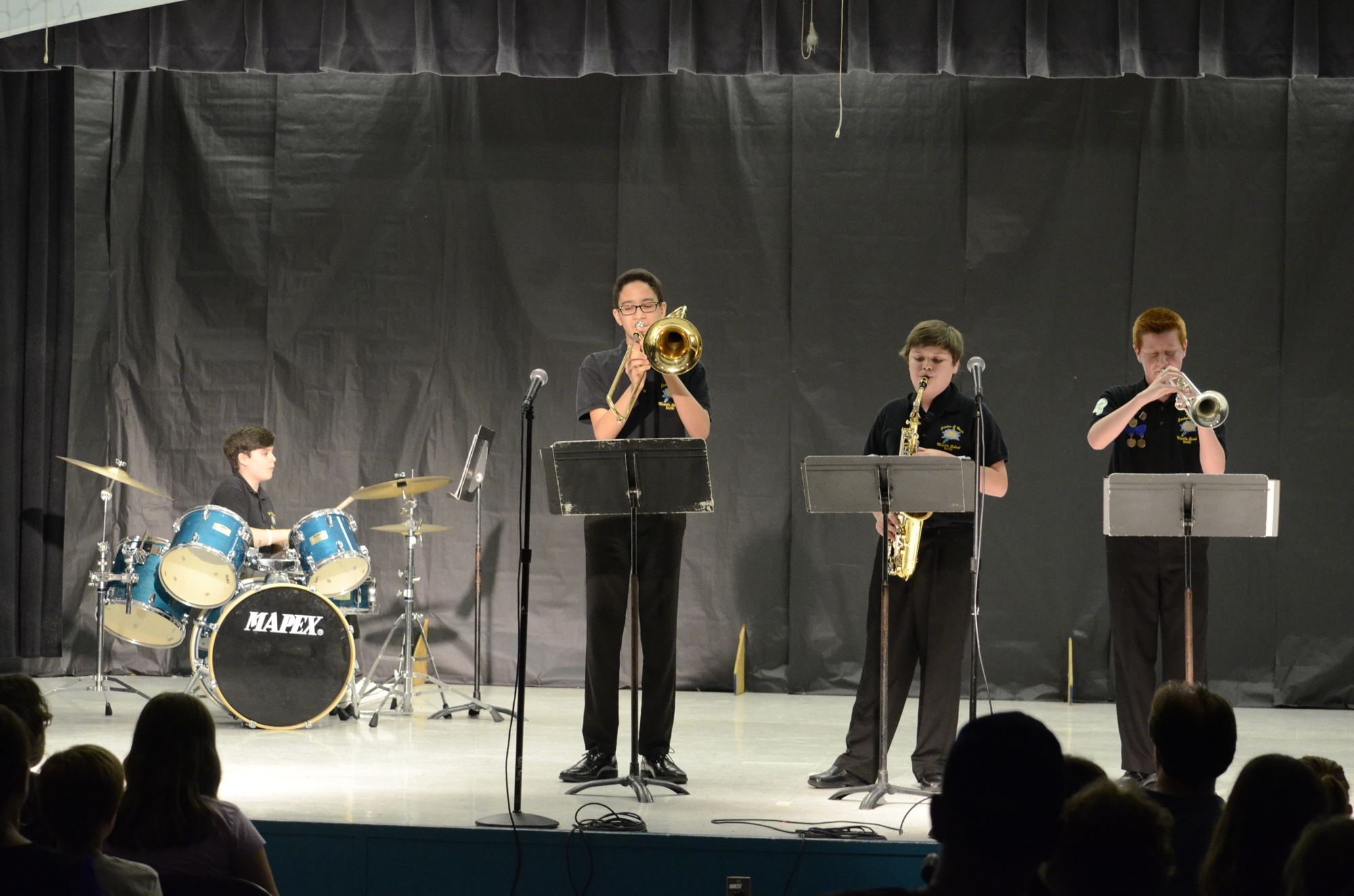 Aidan Mendel on drums, Braden Hameed on trombone, Ethan Horn on saxophone and Eric Miller on trumpet play 
