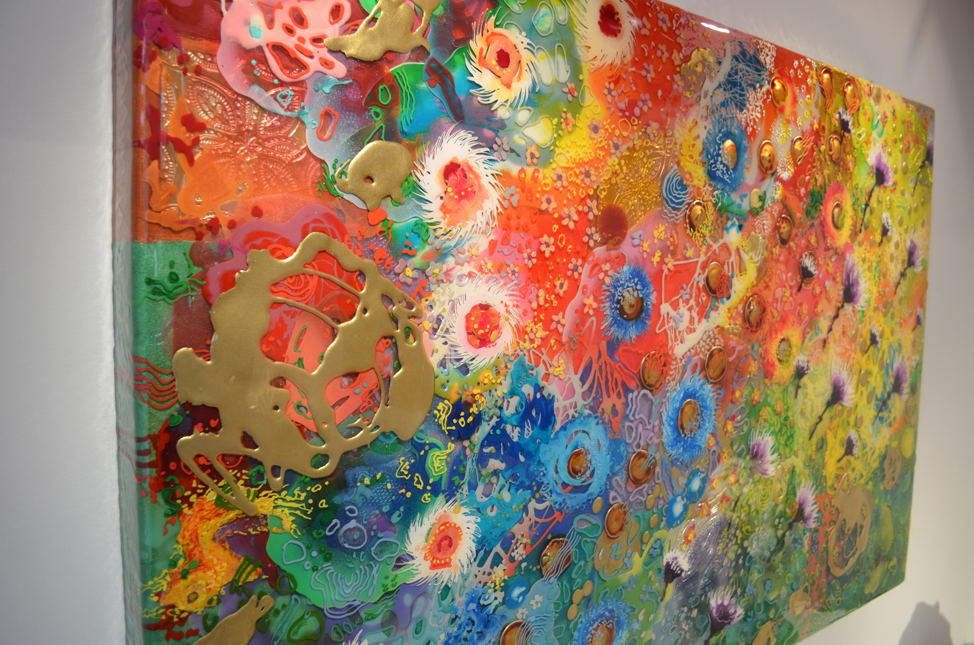 Reich is well-known for her bold, colorful paintings that create depth by layering epoxy resin on a canvas.