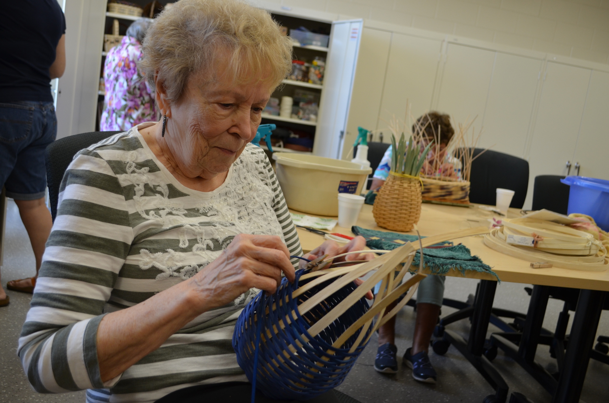 Yvette Muir works on her basket during a class.