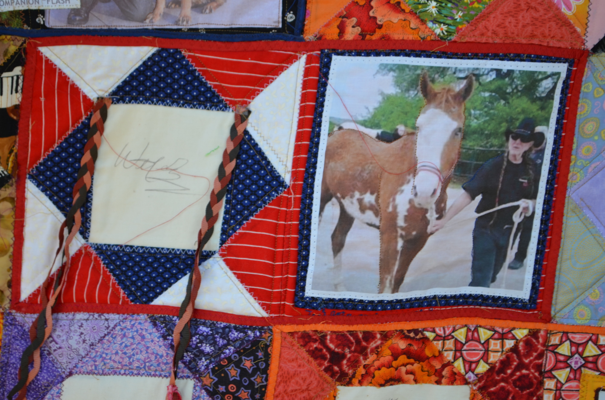Country music artist Willie Nelson signed Joan DaVanzo's quilt. Nelson has a partnership with Habitat for Horses to rescue horses and stop horse slaughter.
