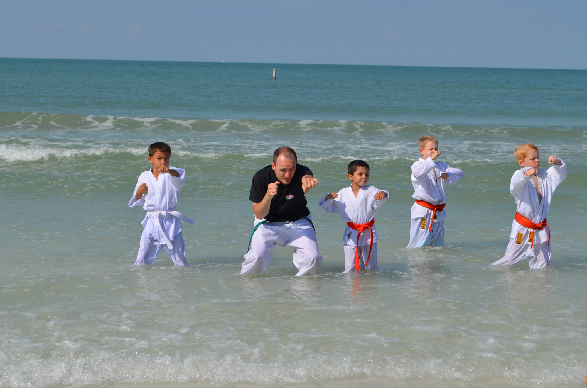 Students of the International martial Arts Academy practice in the waves Saturday morning.