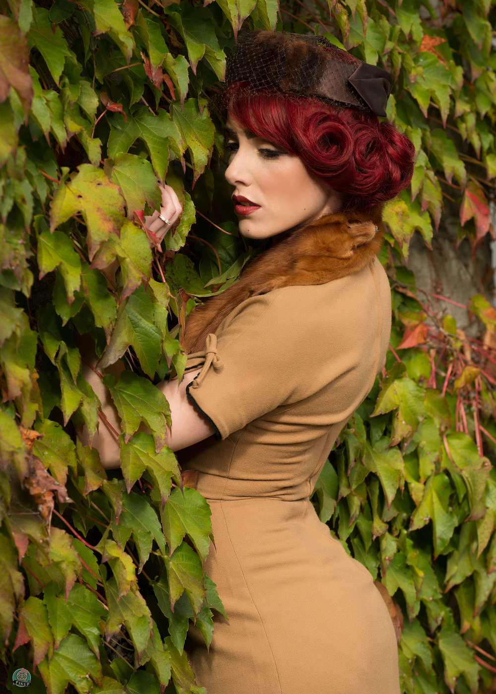 Mercedes Bennett strikes a pinup pose in a vintage dress. Photo by Little Skull Photography. 