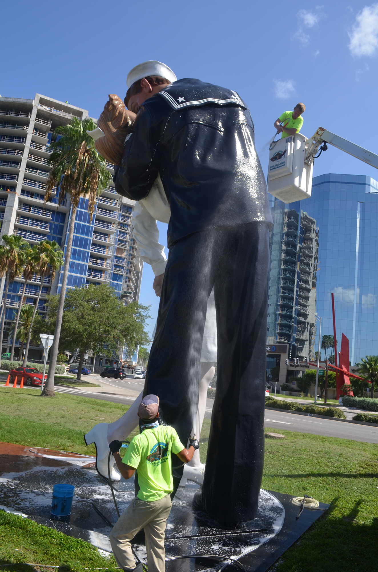 Workers spray the bayfront artwork as part of a pressure-cleaning effort Tuesday morning.