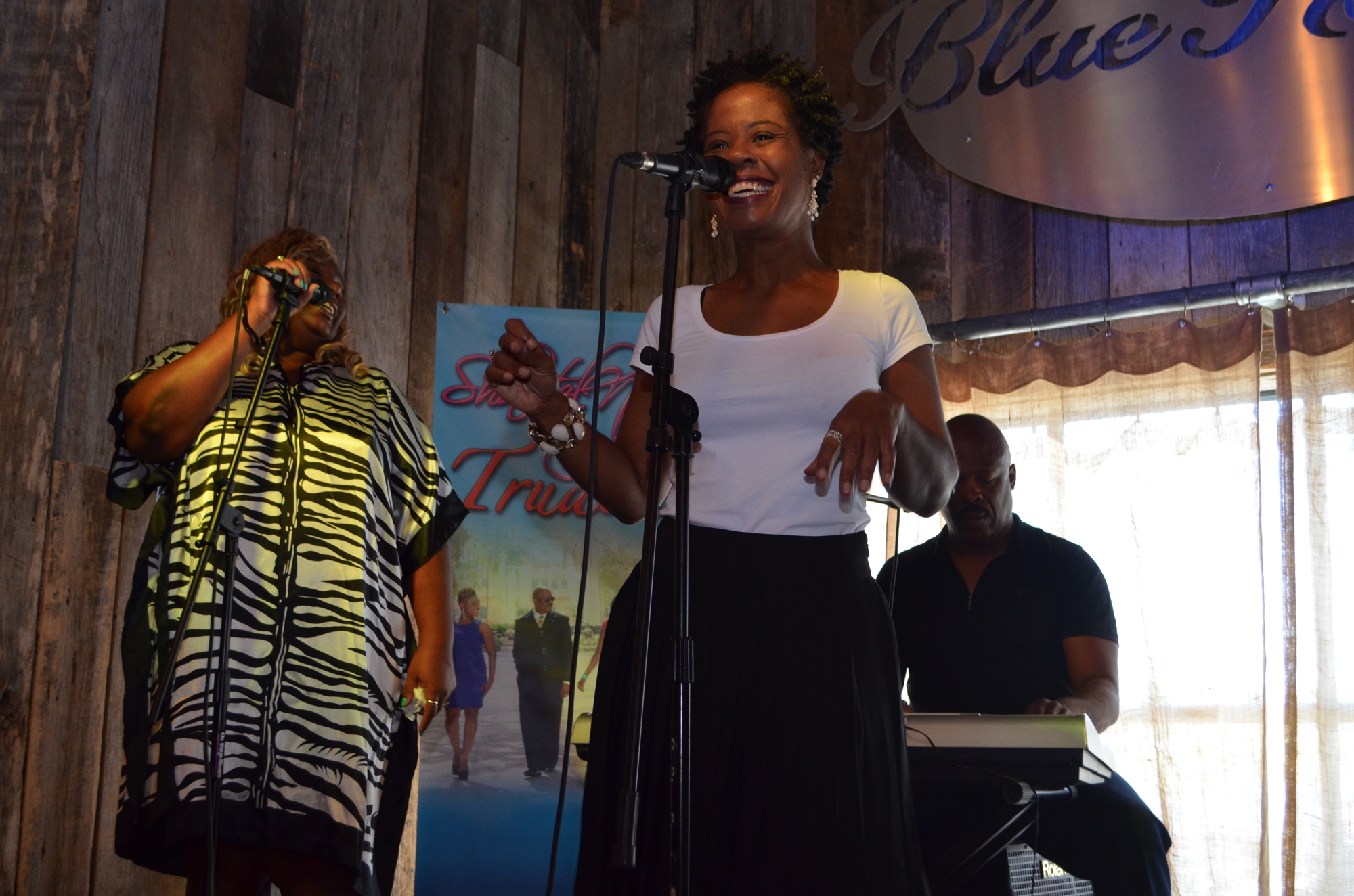 Alto Joycelyn Corbert smiles as she sings with tenor Kimla Murrell and music director Dennis Clove plays piano. The vocalists often incorporate choreographed dance moves into their performances. Photo by Niki Kottmann.