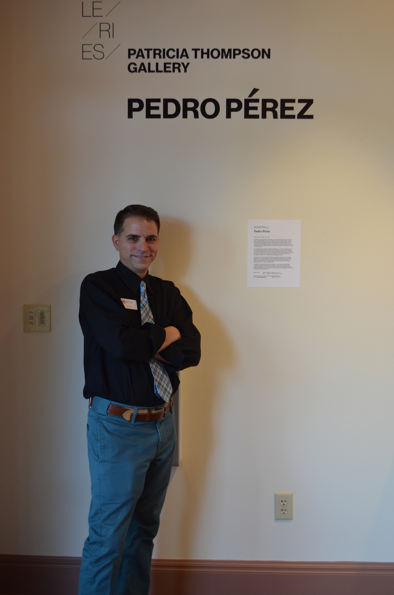 Pedro Pérez poses by the entrance to his exhibit in the Patricia Thompson Gallery at Ringling College of Art and Design.