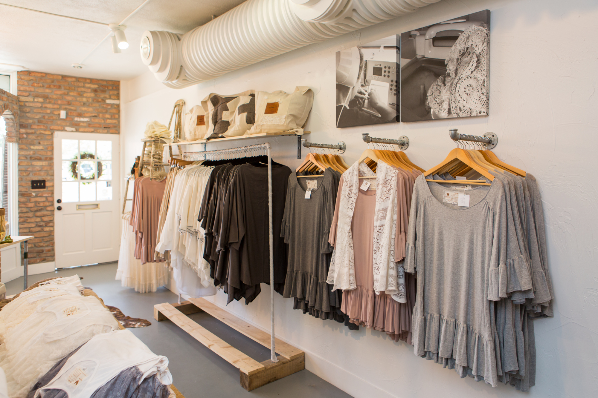 Various frocks and bags line the walls of the Sarasota location of Farmhouse Frocks in Burns Court. Each frock is named after one of the Amish seamstresses who make them. Photo courtesy of Katelyn Prisco Photography.