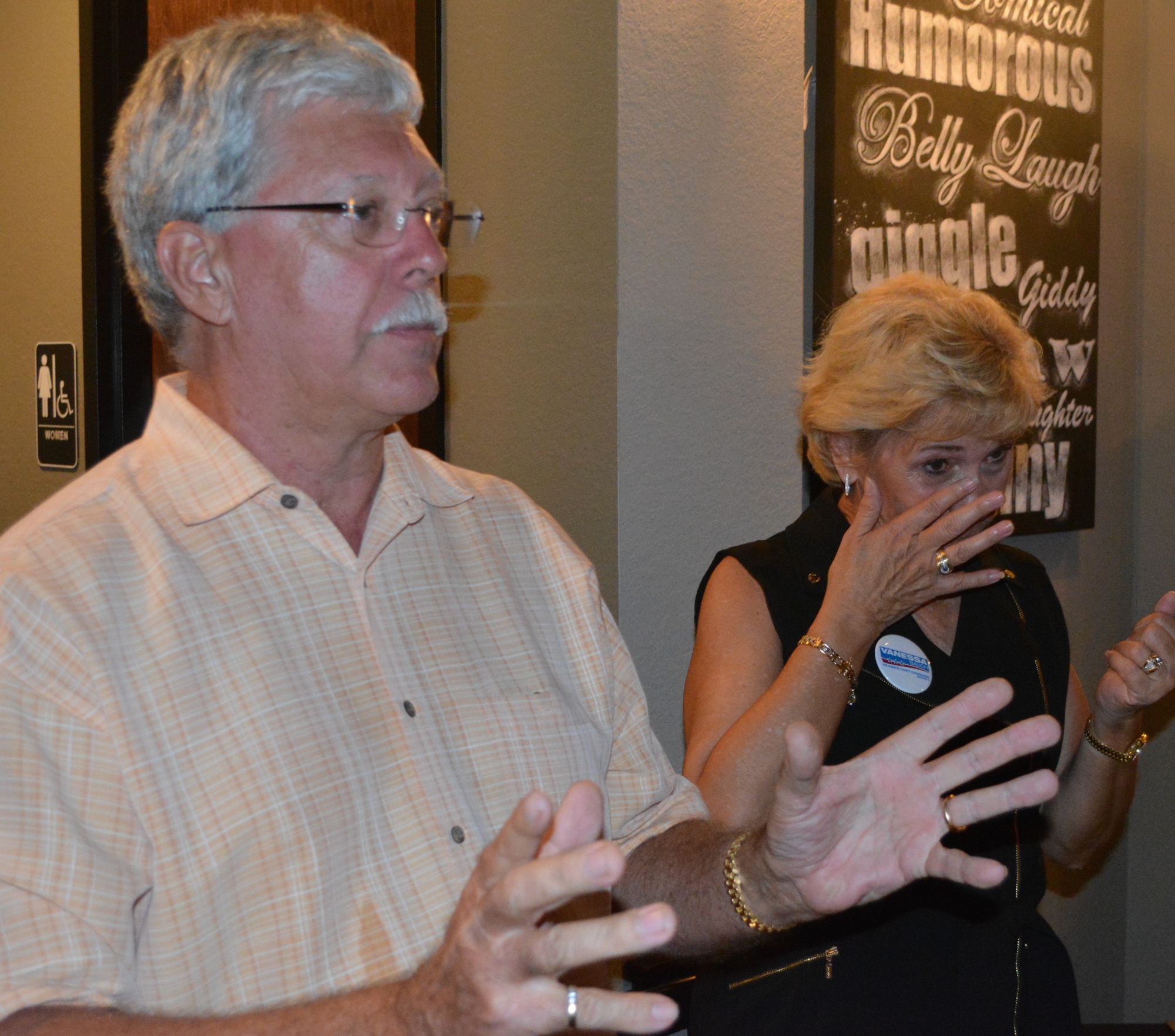 Don Baugh talks about his wife's victory as she struggles with her emotions on Tuesday at Main Street Trattoria.