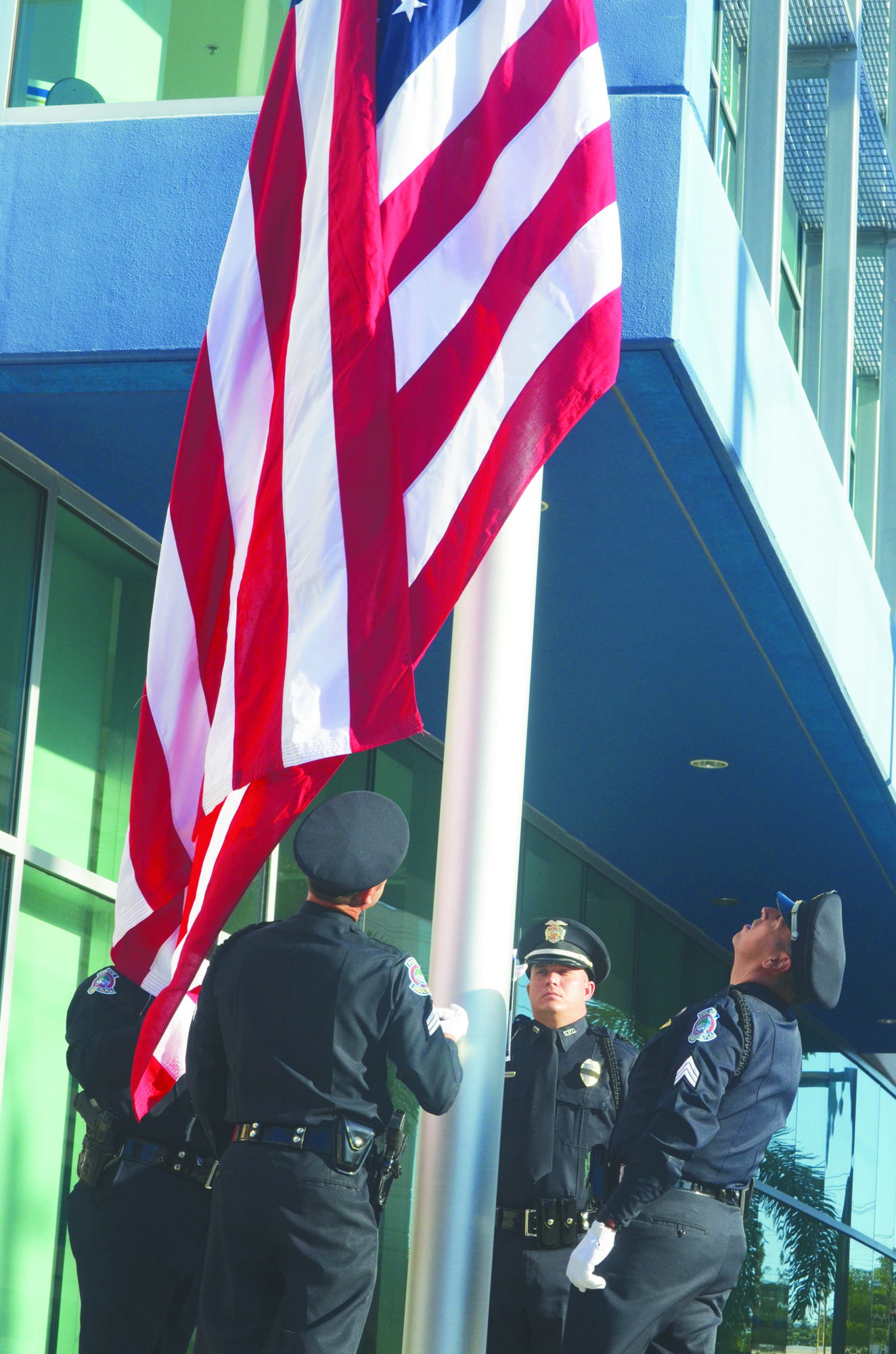 File photo. Sarasota Police Sgts. Mark Opitz, Rex Troche, Mike Schwieterman and Officer Brian Singley raise the American flag during a 2013 ceremony.