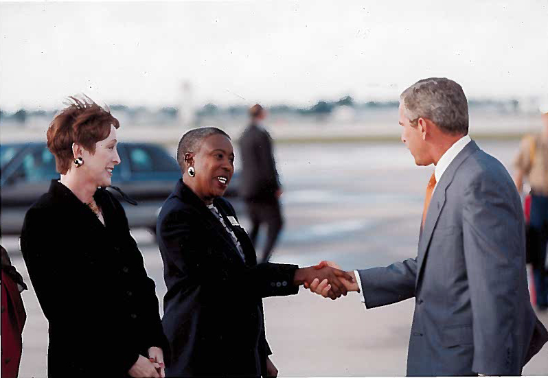 Courtesy photo. Then Sarasota Mayor Carolyn Mason greets President George W Bush on the tarmac to welcome him to town on Sept. 10.
