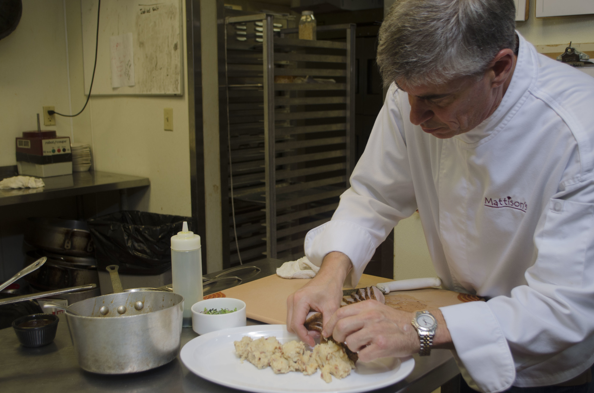 Chef Paul Mattison prepares the Niman Ranch pork dish that he'll serve at Taste of Downtown. Photo by Niki Kottmann.