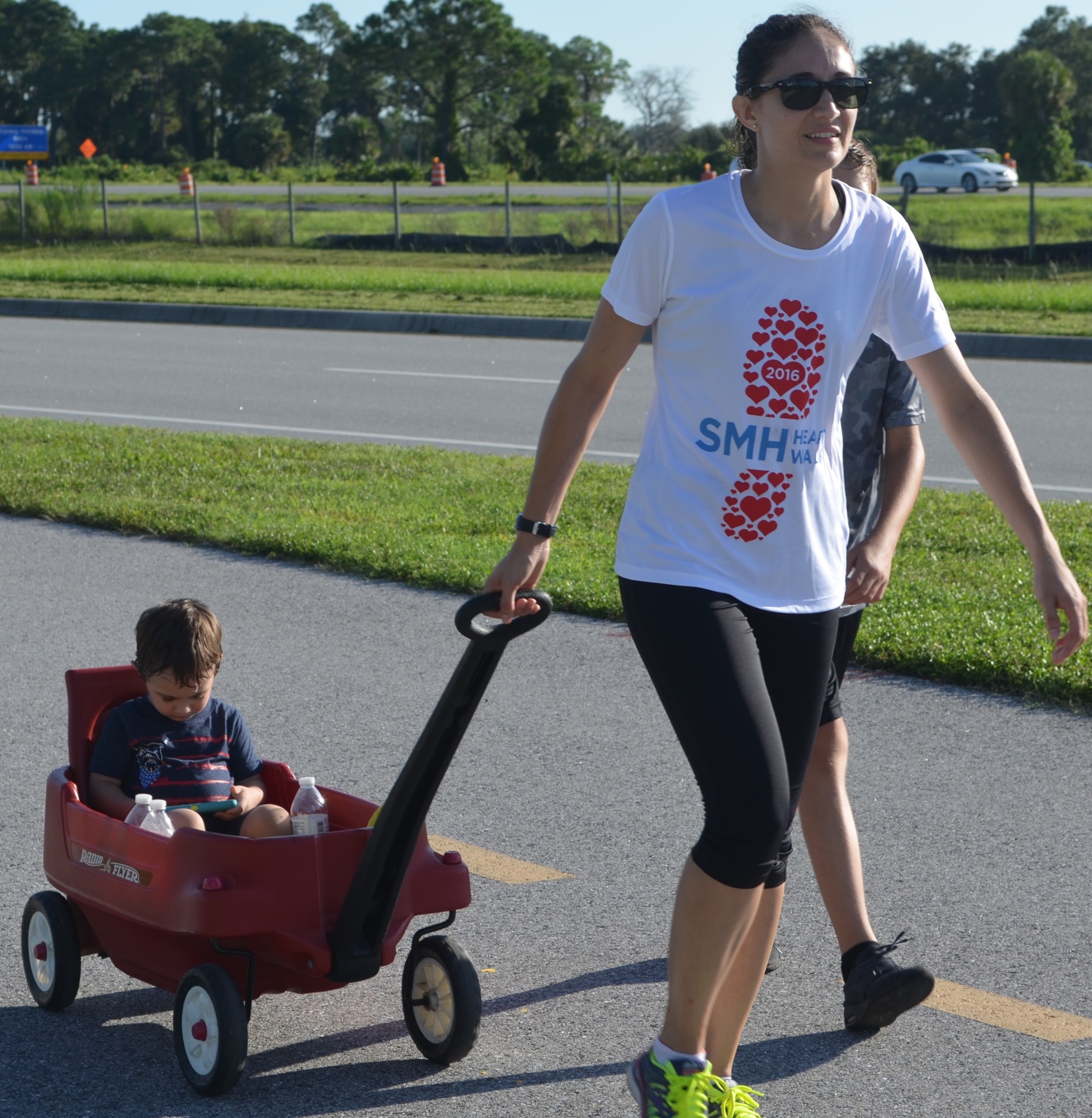 Sarasota's April Smith  pulls her son, 2-year-old Tavian, during the Heart Walk.