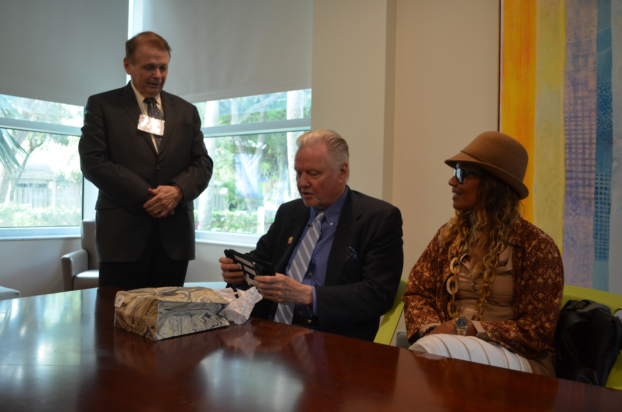 Larry Thompson presents Jon Voight with a gift on behalf of the college.