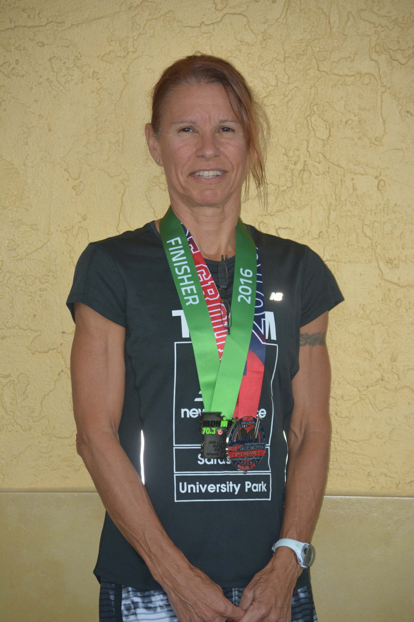 Sarasota triathlete Linda Bayne shows off medals from the IRONMAN 70.3 qualifying race in Augusta, Ga., and from the 2016 Age Group Nationals in Omaha, Neb.