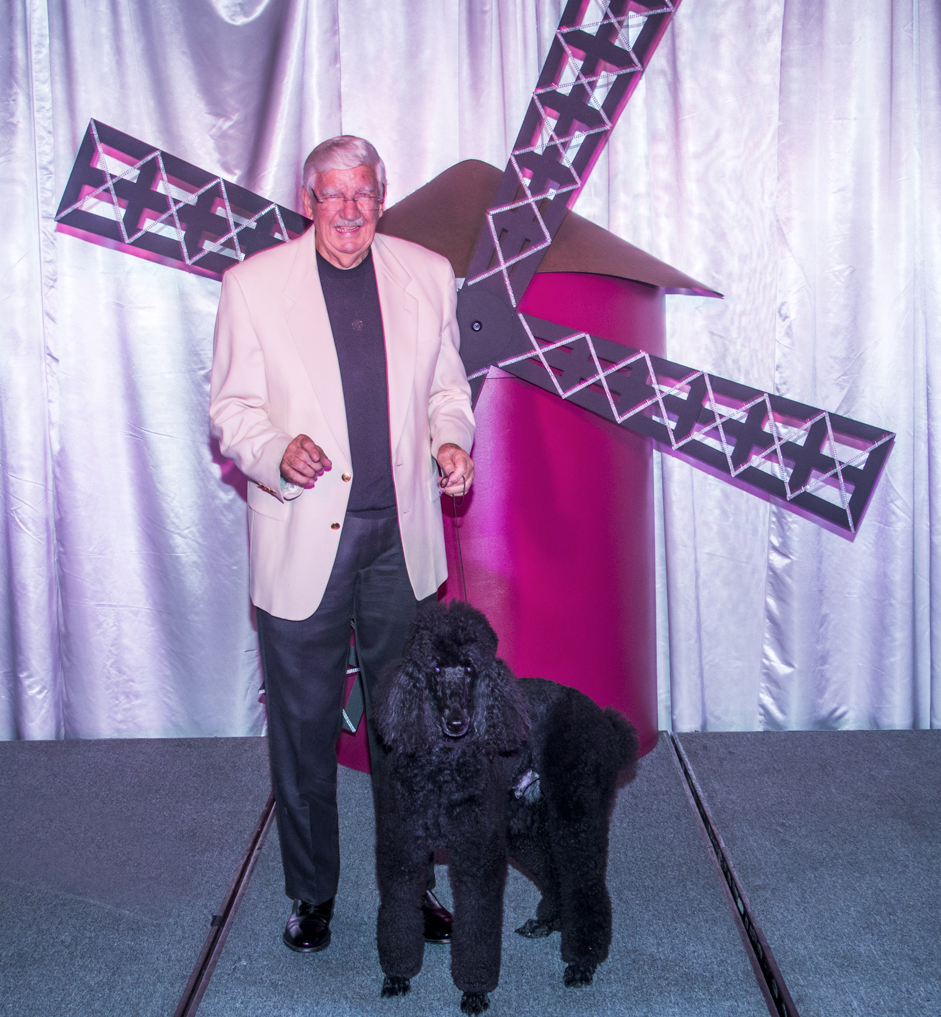 John Hunter and 9-year-old black poodle rescue, Oliver,  on the runway at the Designing Women Boutique fashion show last year. Courtesy photo.