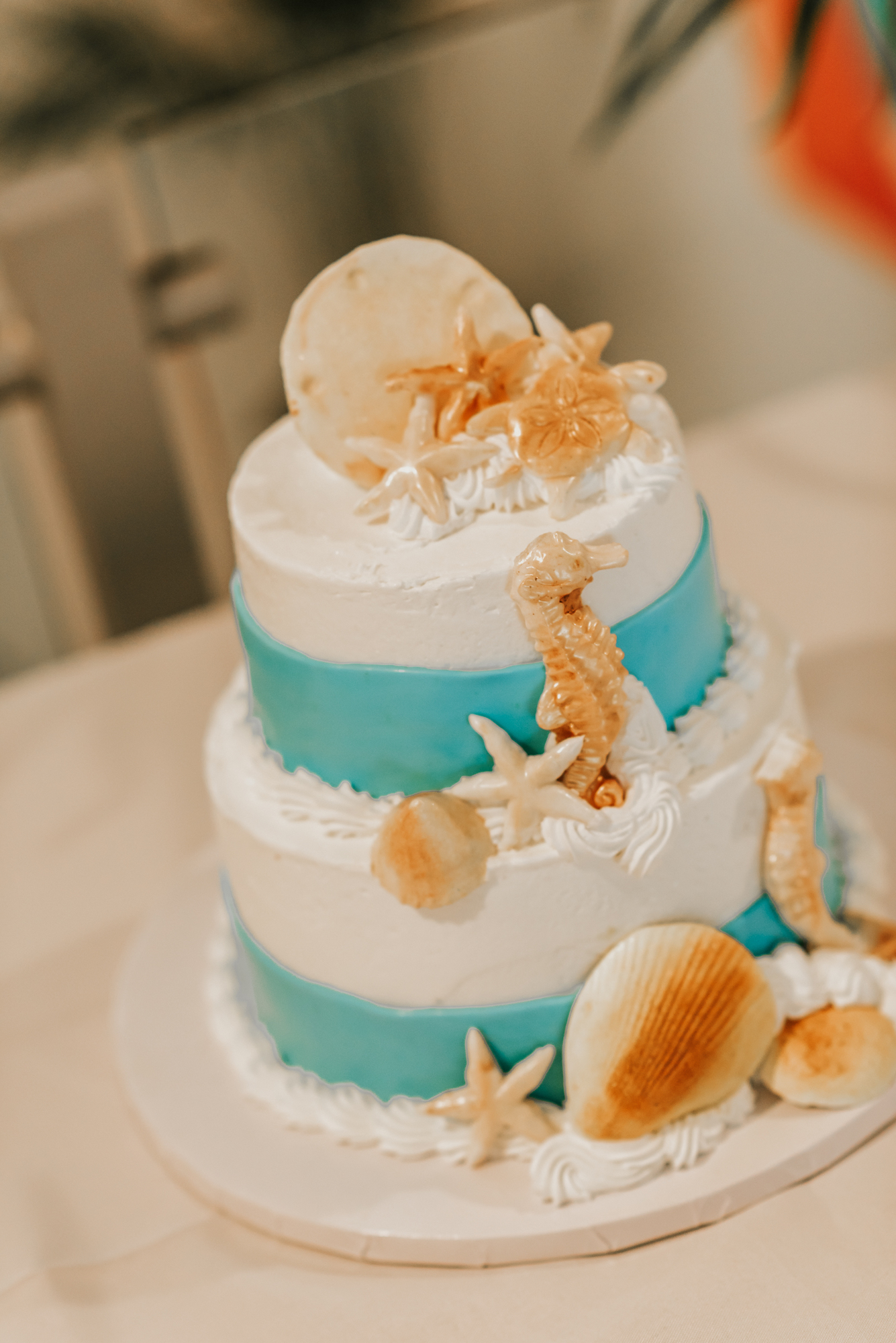 Elana and Marc's wedding cake was adorned with seashells and pineapple jam. Photo by Regina Rached.