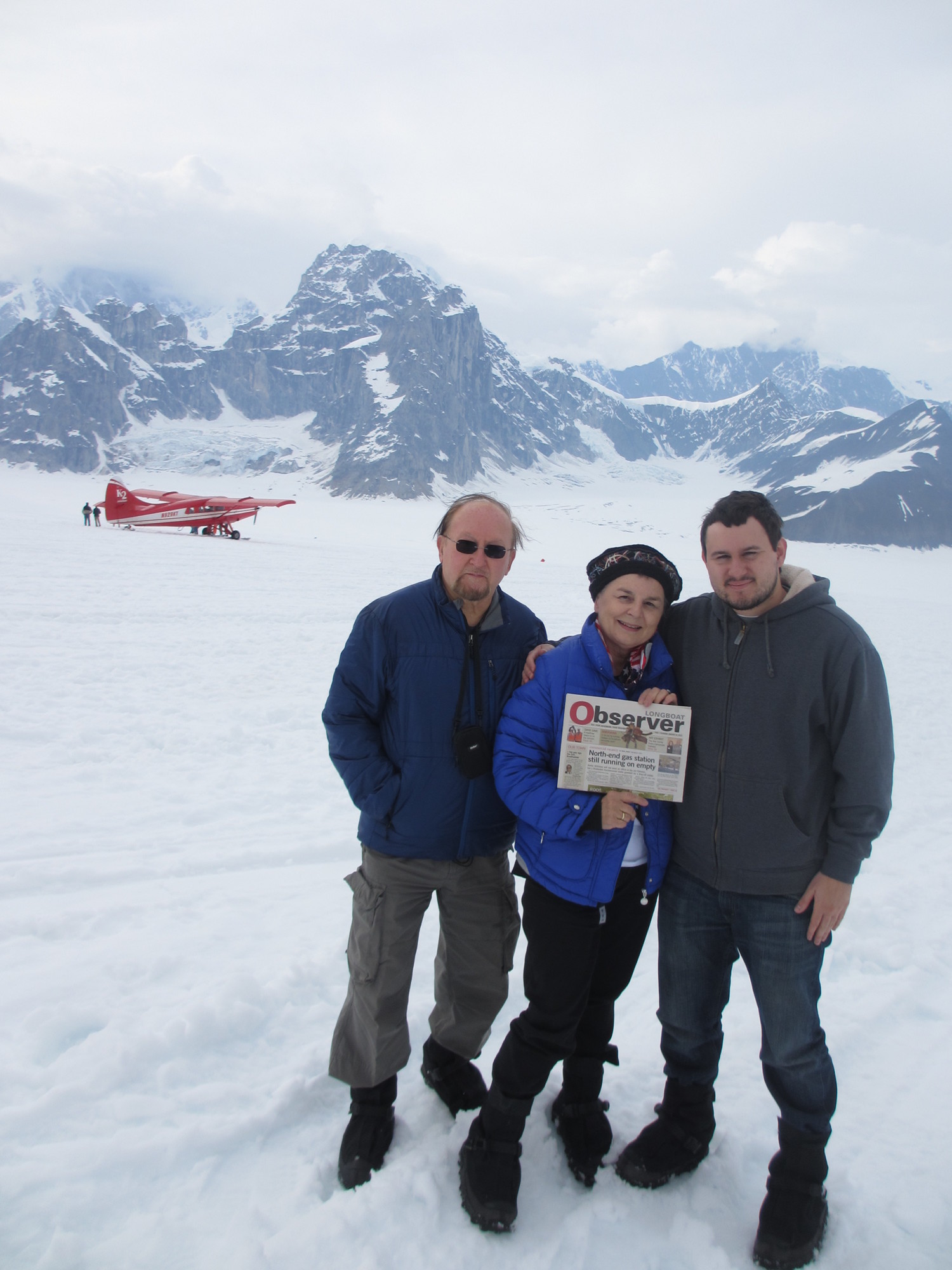 George, Anisa and Maksym Mycak, of Longboat Key, display their Longboat Observer on a flightseeing landing in the Don Sheldon Amphitheater of Alaska’s Ruth Glacier, which flows off Denali, the highest peak in North America.